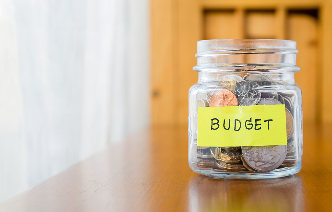Mason jar with coins text on jar says "Budget"
