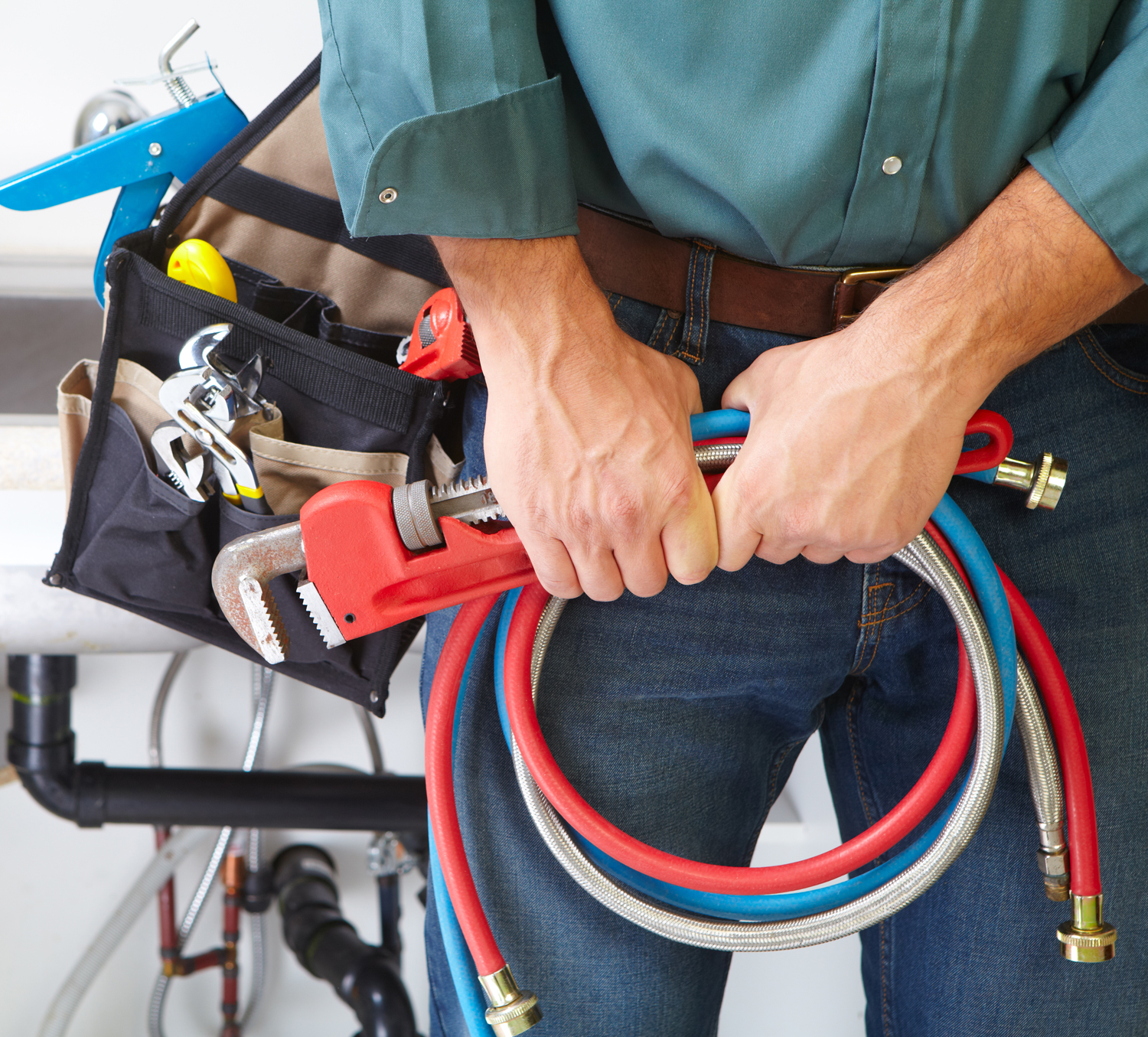 Plumber's hands with this tools in his hand.